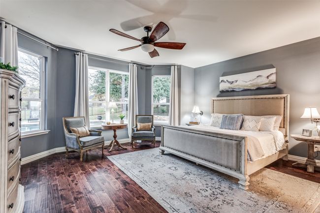 Bedroom with multiple windows, dark wood-style flooring, and ceiling fan | Image 20