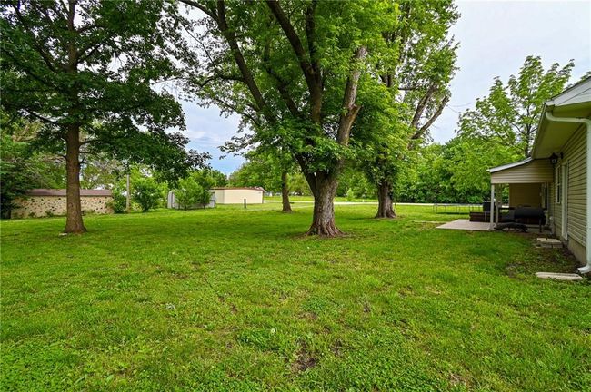 View of grassy yard with a patio area | Image 35