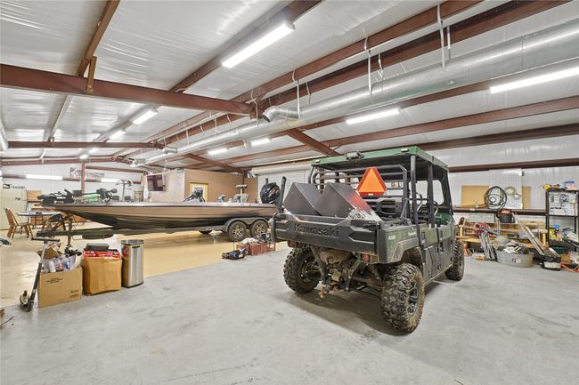 Garage featuring a workshop area | Image 31