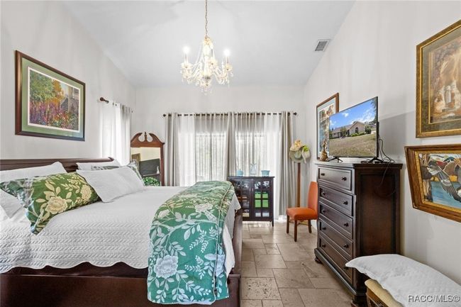 master bedroom with view to the screened porch and garden | Image 13