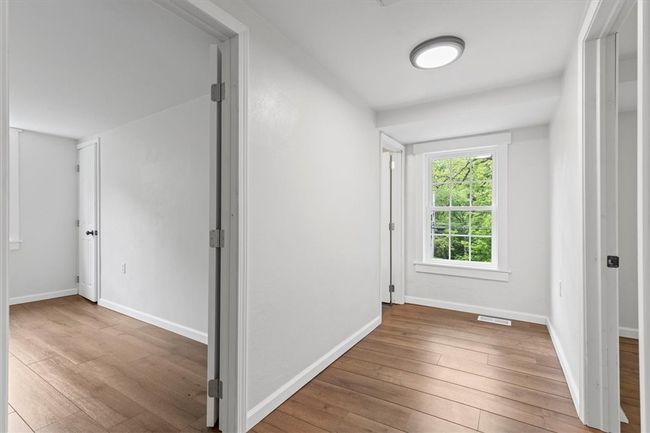 Upstairs hallway leading to bathroom and bedrooms | Image 18