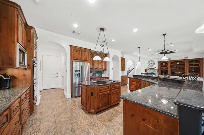 Included is an abundance of counter, cabinet & drawer storage along with pots & pans storage drawers and a spacious walk-in pantry. | Image 15