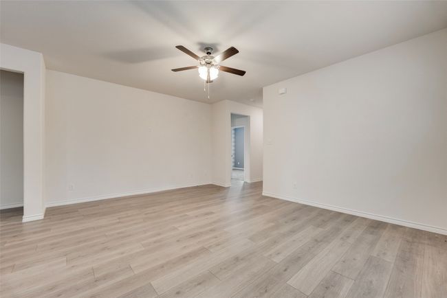 Unfurnished room featuring ceiling fan, light wood-type flooring, and baseboards | Image 13