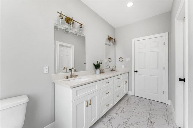 Elegant double sinks in the primary bathroom. | Image 17