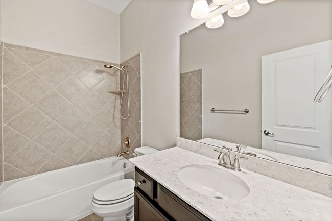 Full bath featuring toilet, tub / shower combination, and vanity | Image 33