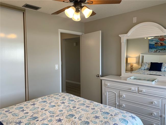 Bedroom featuring a ceiling fan | Image 18