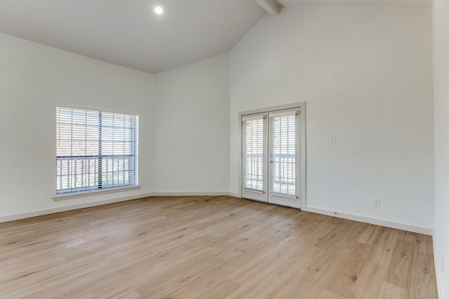 Empty room with french doors, beamed ceiling, light hardwood / wood-style floors, and high vaulted ceiling | Image 35