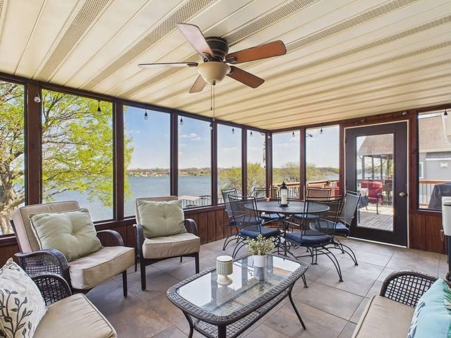 Sunroom with a water view, ceiling fan, outdoor dining space, and an outdoor hangout area | Image 14