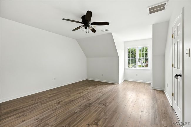 Another view of 4th bedroom featuring Laminate-style flooring, a ceiling fan | Image 28
