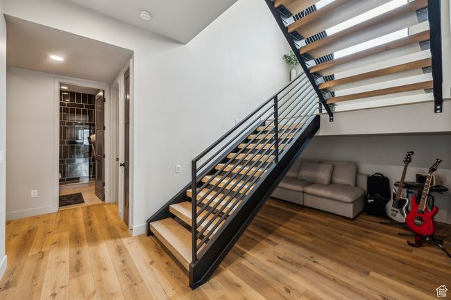 Stairway featuring hardwood / wood-style floors, baseboards, and recessed lighting | Image 44