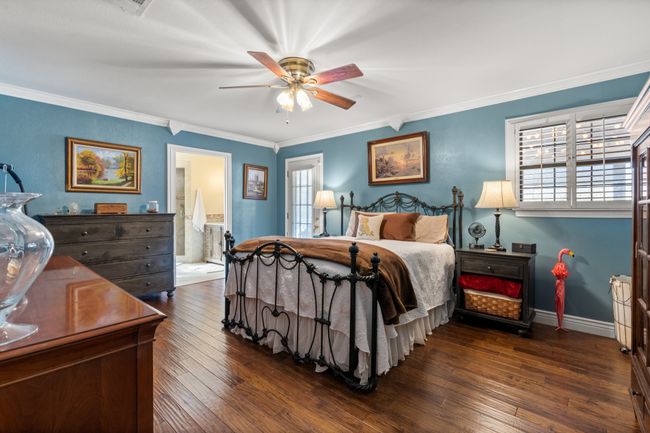 Primary Bedroom with multiple windows, Ensuite bathroom, ceiling fan, and crown molding | Image 24