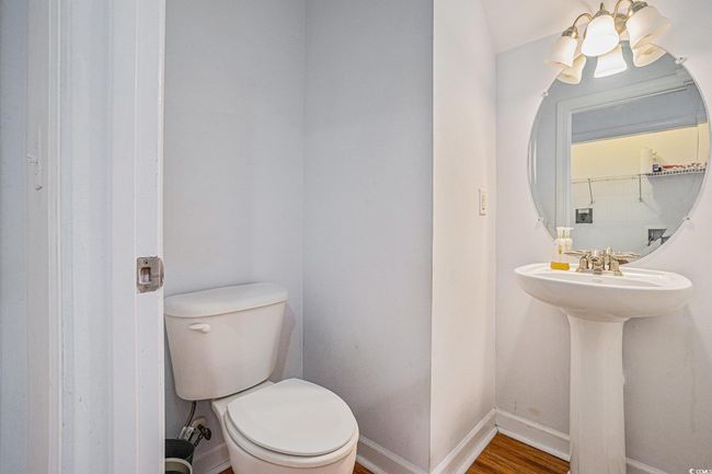 Half bath featuring toilet and wood finished floors | Image 8