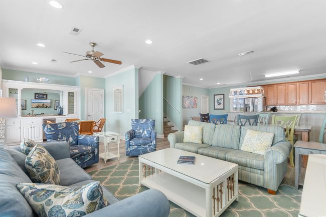 Oceanfront Living area with LVT floors, coastal decor, and plenty of natural light | Image 21