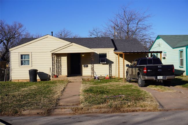 View of front of house featuring a front lawn and a carport | Image 4