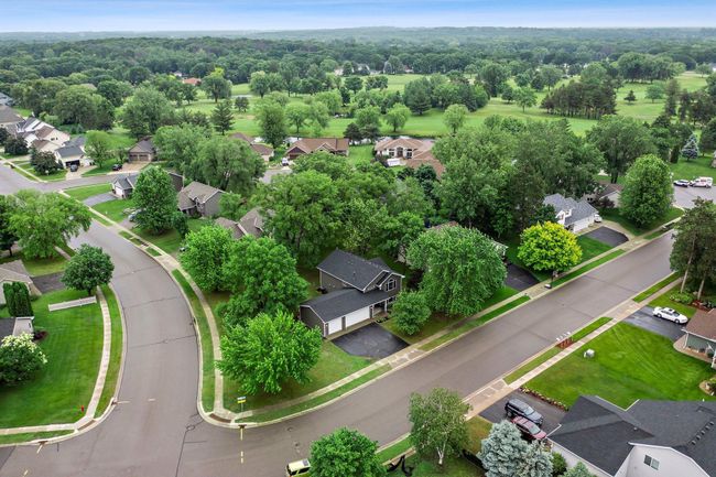 An aerial view showcasing the new roof (2024), large corner lot, and mature trees. | Image 21