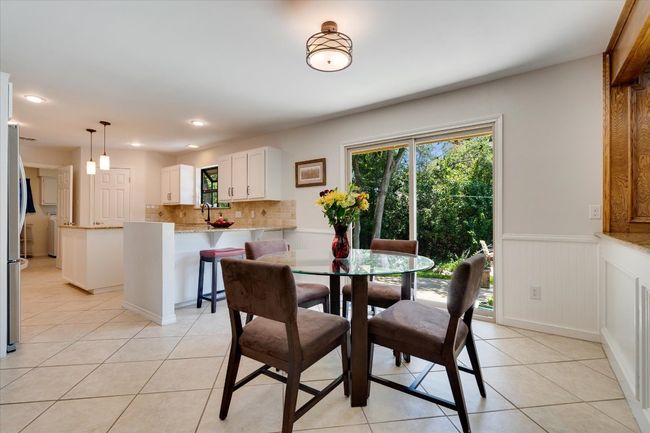 Dining space featuring light tile patterned floors, wainscoting, and recessed lighting | Image 14