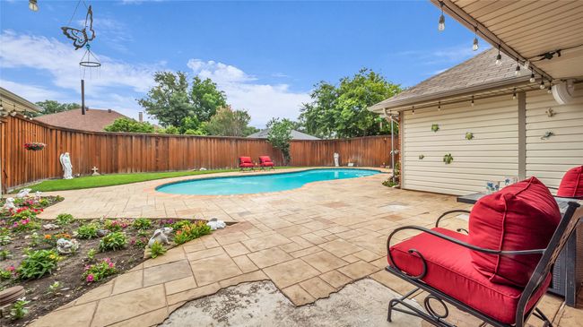 View of pool with a patio area and a fenced backyard | Image 25
