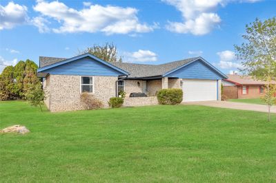 Single story home featuring a front yard and a garage | Image 2