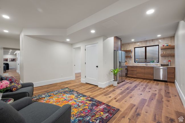 Living area with light wood-style floors and recessed lighting | Image 57