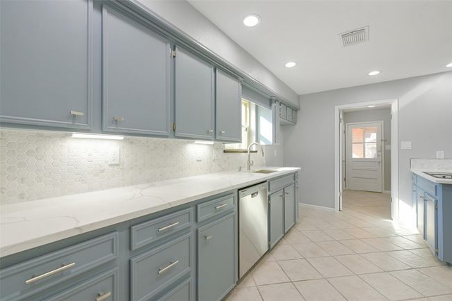 Look at all this counter space. Door way to utility room and backyard. | Image 11