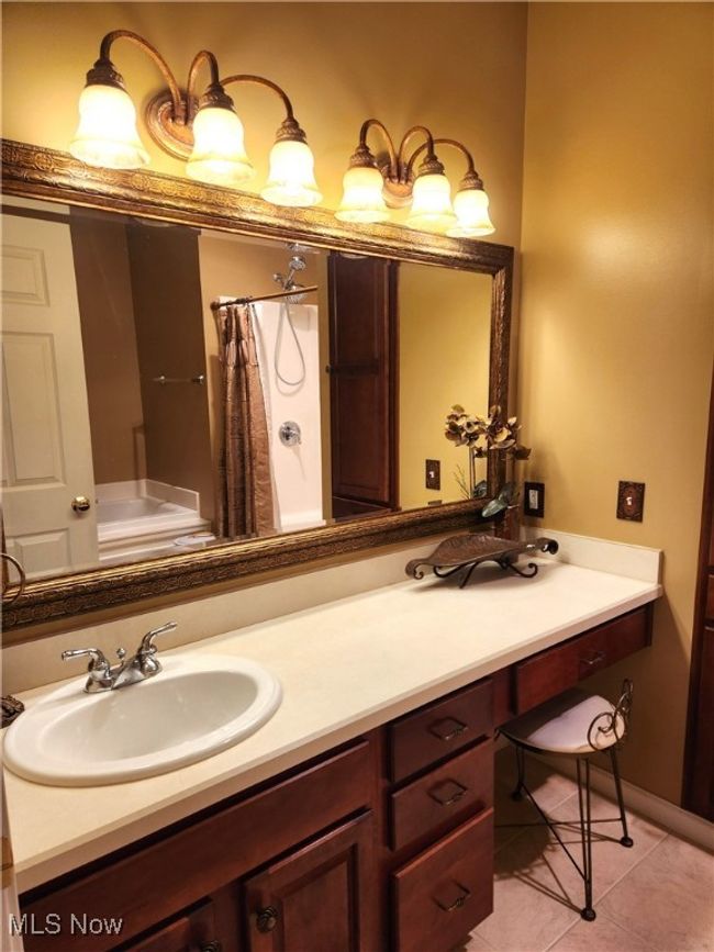 Bathroom featuring vanity, curtained shower, and tile patterned floors | Image 24