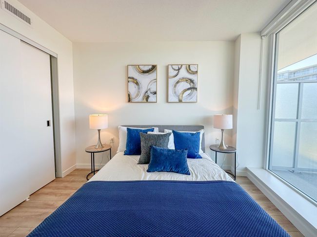 Bedroom with wood finished floors and baseboards | Image 11