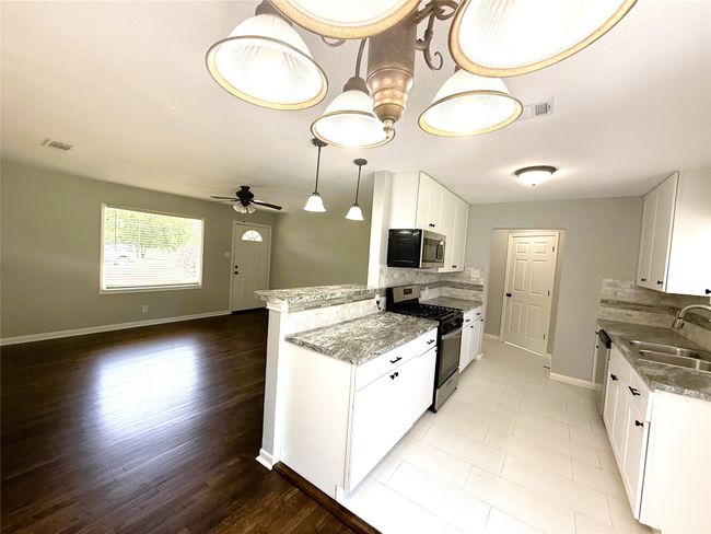 Kitchen with a sink, backsplash, stainless steel appliances | Image 7