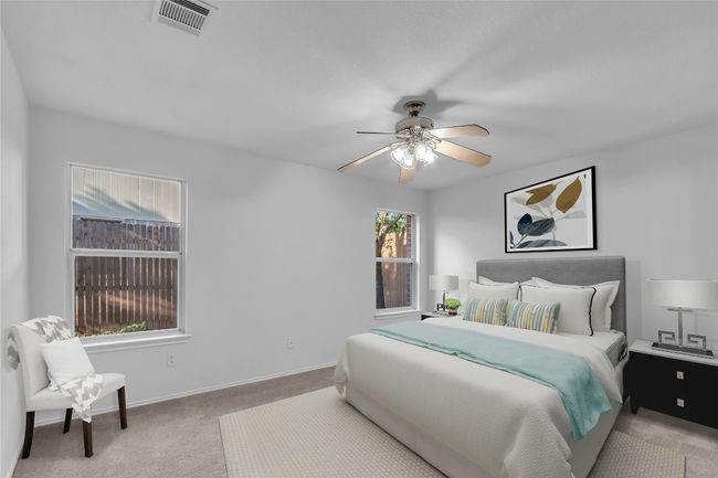 Bedroom with carpet flooring and a ceiling fan | Image 7