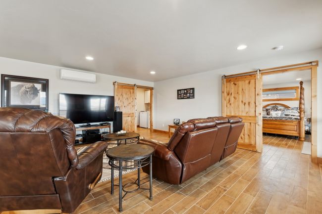 Living room featuring a wall unit AC and a barn door | Image 30