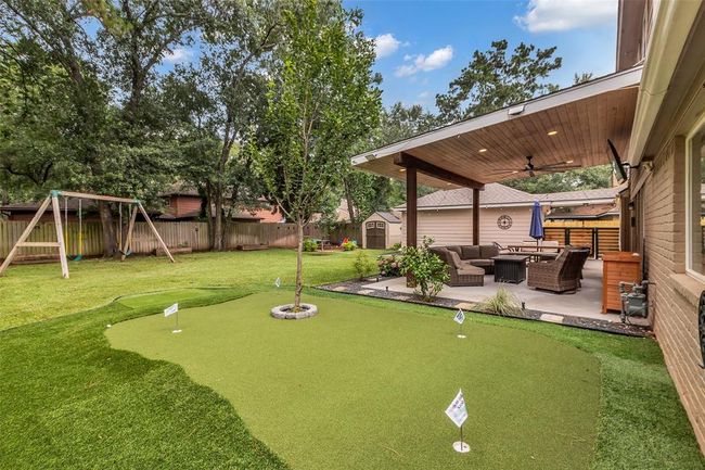 Custom putting green with 4 holes in the backyard. | Image 8