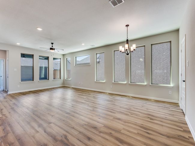 With large picture windows and beautiful flooring, who wouldn't love to entertain in this wonderful open concept family room & dining area? | Image 10