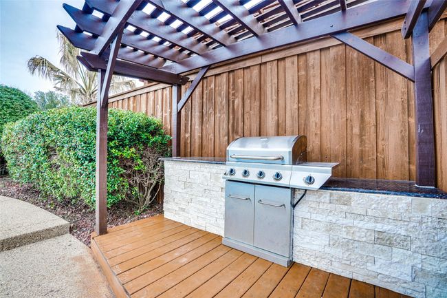 Wooden deck featuring a pergola and a grill | Image 23