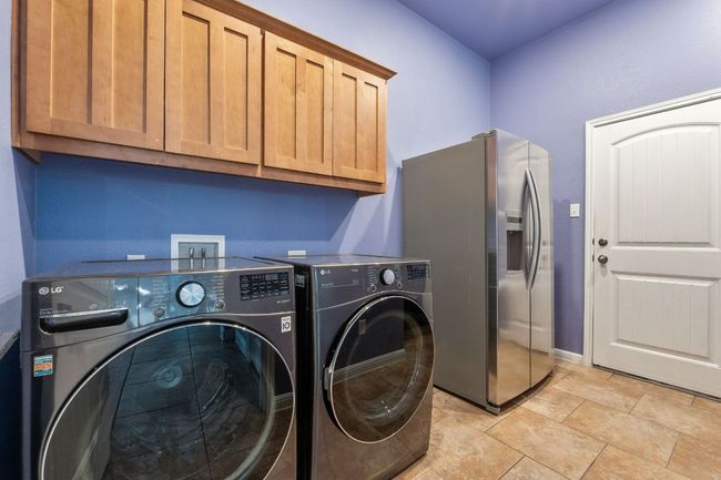 Large utility room has plenty of cabinets, and also has plenty of room for an extra freezer or fridge. | Image 18