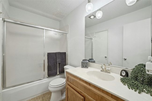 The large bathroom is accessible from either the hallway, or the primary suite. It has a shower/tub combination. | Image 15