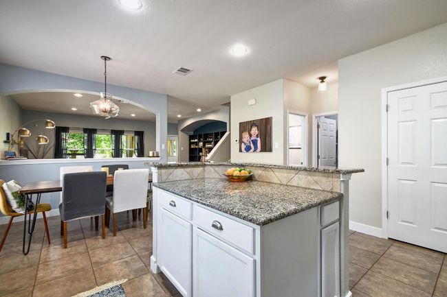 The kitchen is open to the dining area making meal transfer as easy as ever. | Image 13