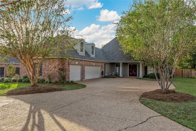 View of front of house with a front yard and a garage | Image 1