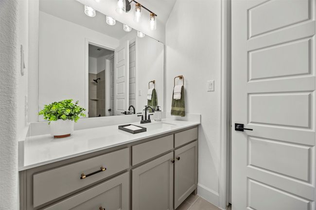 Full bathroom featuring vanity, tiled shower, and tile patterned flooring | Image 24