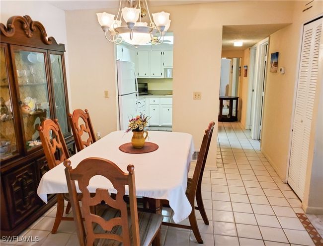 Dining room featuring a notable chandelier and light tile patterned floors | Image 9