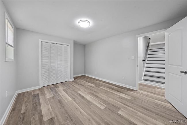 Unfurnished bedroom with baseboards, light wood-type flooring, and a closet | Image 23