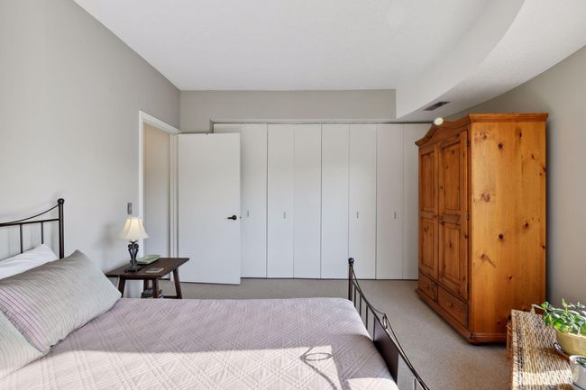 Sunny and serene owner's bedroom with beautiful views and a full wall of closets. | Image 15