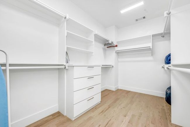 Walk in closet featuring light hardwood / wood-style floors | Image 32