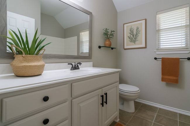 Bathroom with vaulted ceiling, vanity, baseboards, toilet, and tile patterned flooring | Image 24