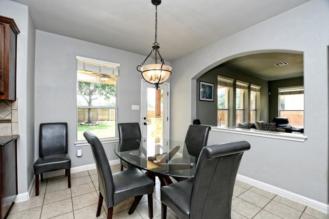Dining area with arched walkways, light tile patterned floors, and baseboards | Image 7