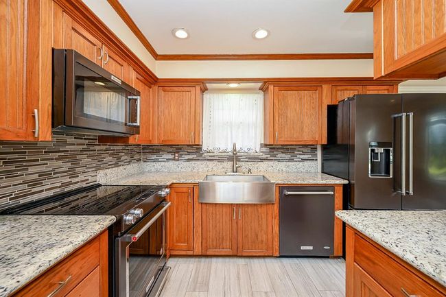 No detail was overlooked when designing the kitchen! Cabinets also include large pull-out drawers. BONUS: The refrigerator remains with the home. | Image 11