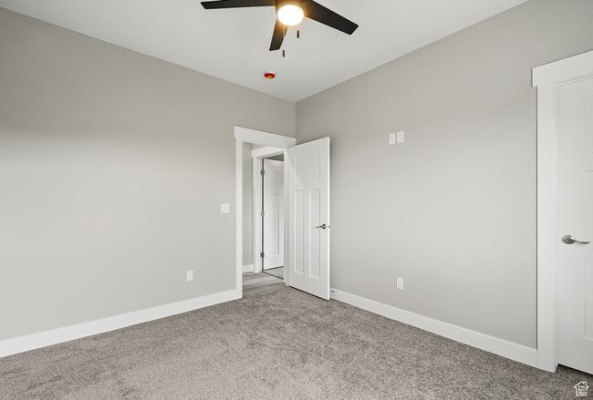 Unfurnished room with carpet flooring, ceiling fan, and baseboards | Image 41