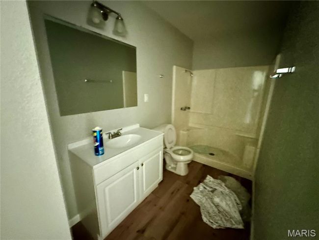 Full bath with wood finished floors, walk in shower, and vanity | Image 9