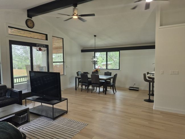 Living area with ceiling fan and light wood-type flooring | Image 4