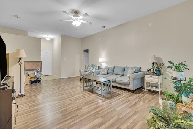 Living room featuring ceiling fan and light wood finished floors | Image 5
