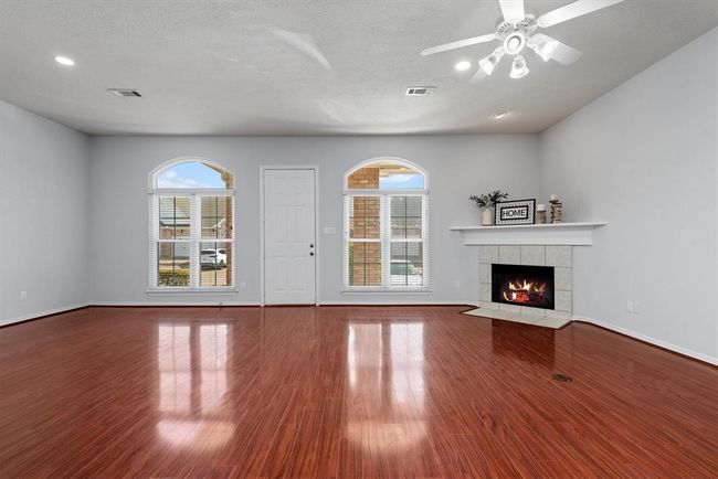Oversized windows flood the room with natural light creating a bright and inviting atmosphere. | Image 7