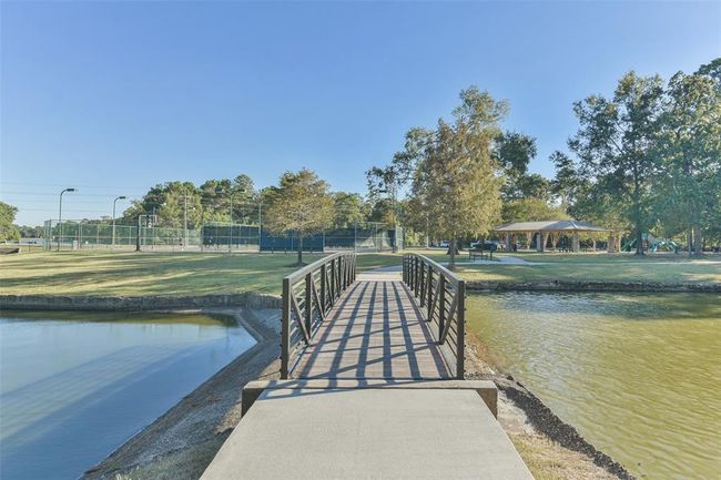 Discover serene living with amenities at your doorstep: pristine tennis courts, a charming covered picnic pavilion perfect for outdoor dining and gatherings, and a vibrant playground at the tranquil Liberty Lake Park. | Image 46